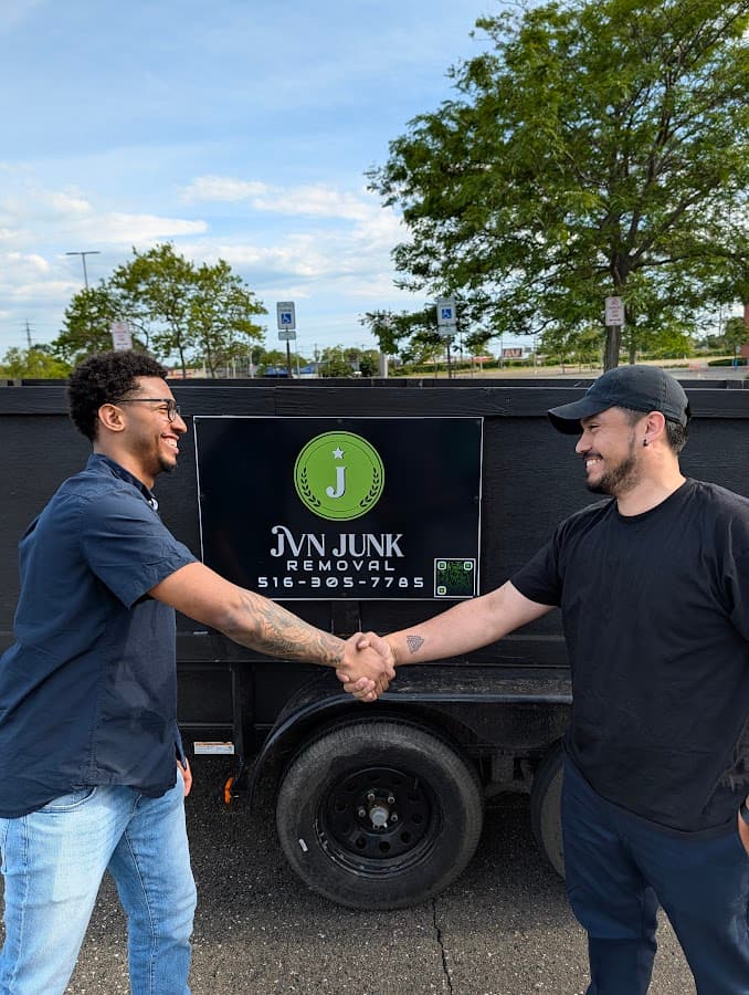 Customer and service professional shaking hands near service truck